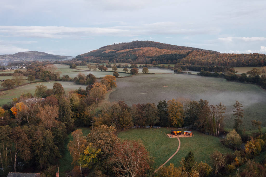 Aerial view of Millie the Hut, its outdoor shelter and the surrounding meadow